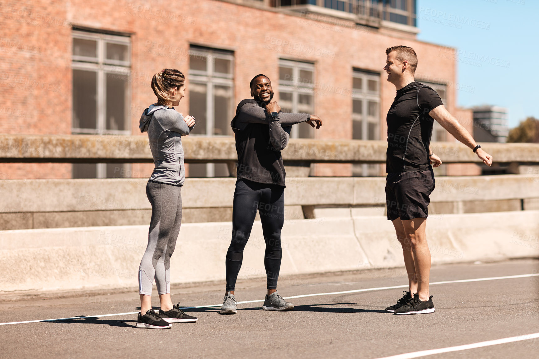 Buy stock photo Shot of a group of sporty young people out exercising together