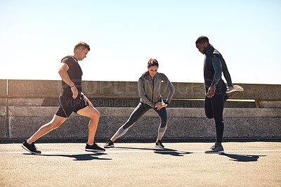 Buy stock photo Shot of a group of sporty young people out exercising together