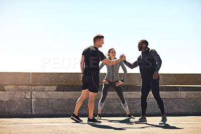 Buy stock photo Shot of a group of sporty young people out exercising together