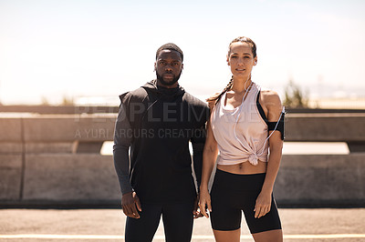 Buy stock photo Shot of two sporty young people standing together while out for a run