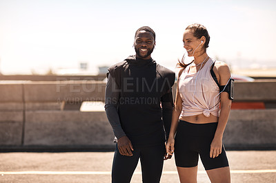 Buy stock photo Shot of two sporty young people standing together while out for a run