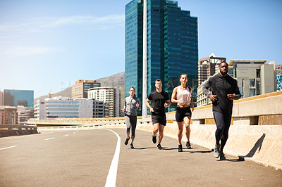Buy stock photo Shot of a group of sporty young people out exercising together