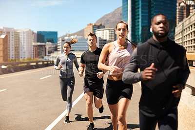 Buy stock photo Shot of a group of sporty young people out exercising together