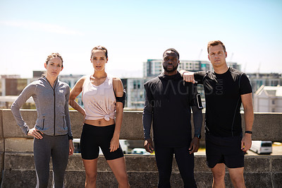 Buy stock photo Shot of a group of sporty young people out exercising together