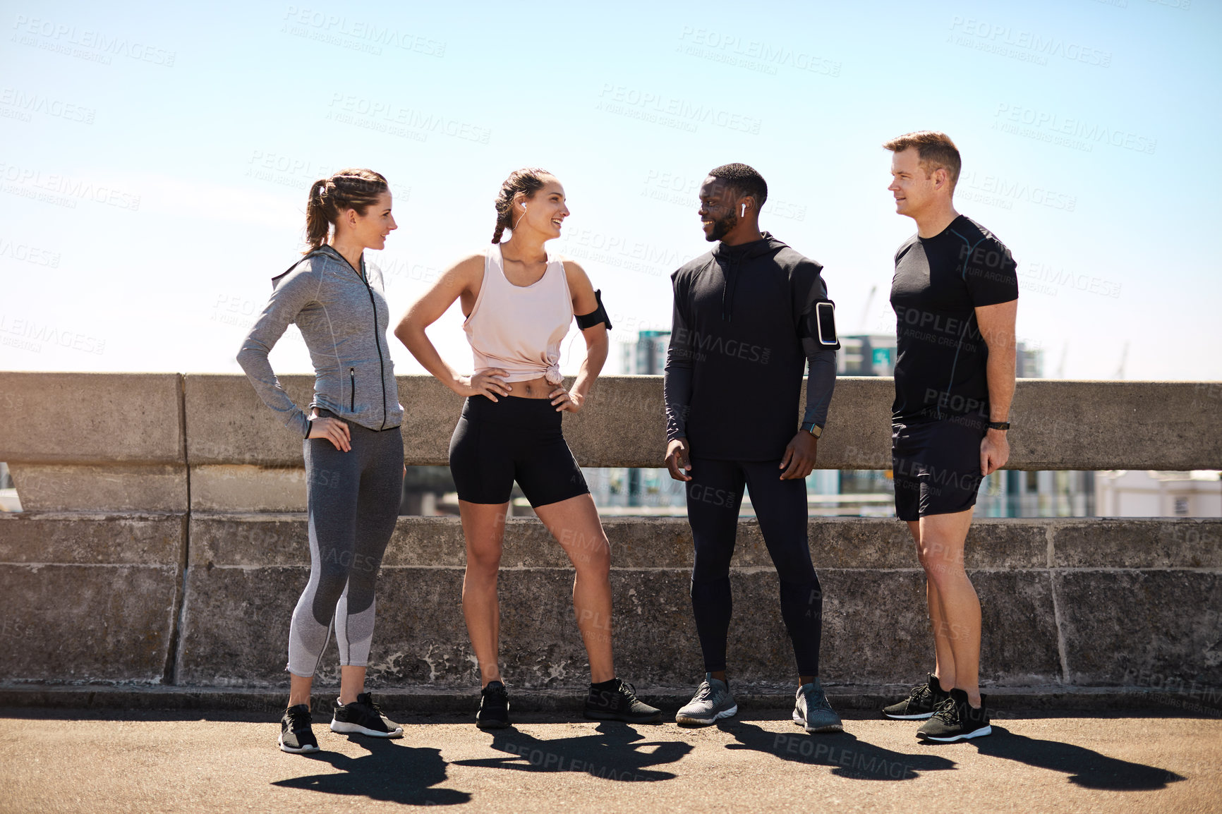 Buy stock photo Shot of a group of sporty young people out exercising together