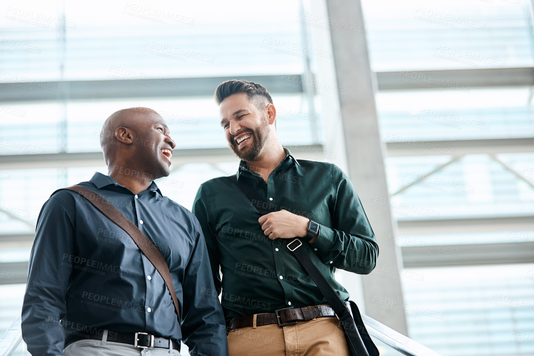 Buy stock photo Cropped shot of two businessmen talking while standing in their office