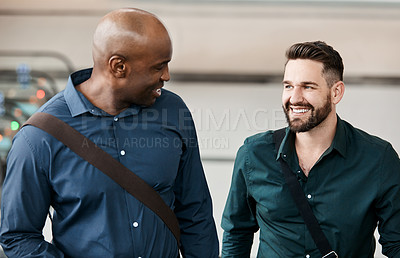 Buy stock photo Cropped shot of two businessmen talking while standing in their office