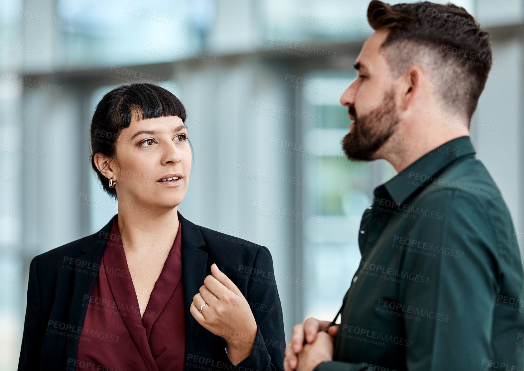 Buy stock photo Cropped shot of two business colleagues talking while standing in their office