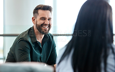 Buy stock photo Cropped shot of two business colleagues sitting down during a meeting in their office