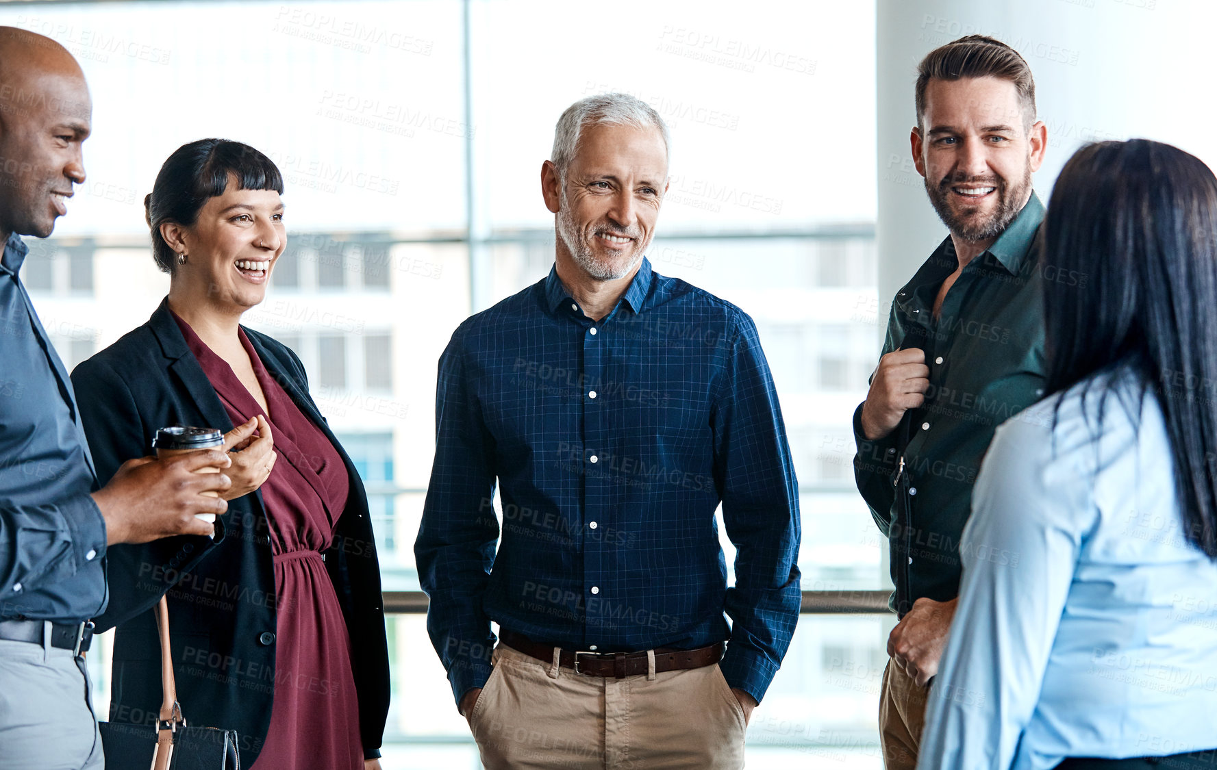 Buy stock photo Cropped shot of a group of business colleagues talking while standing in their office