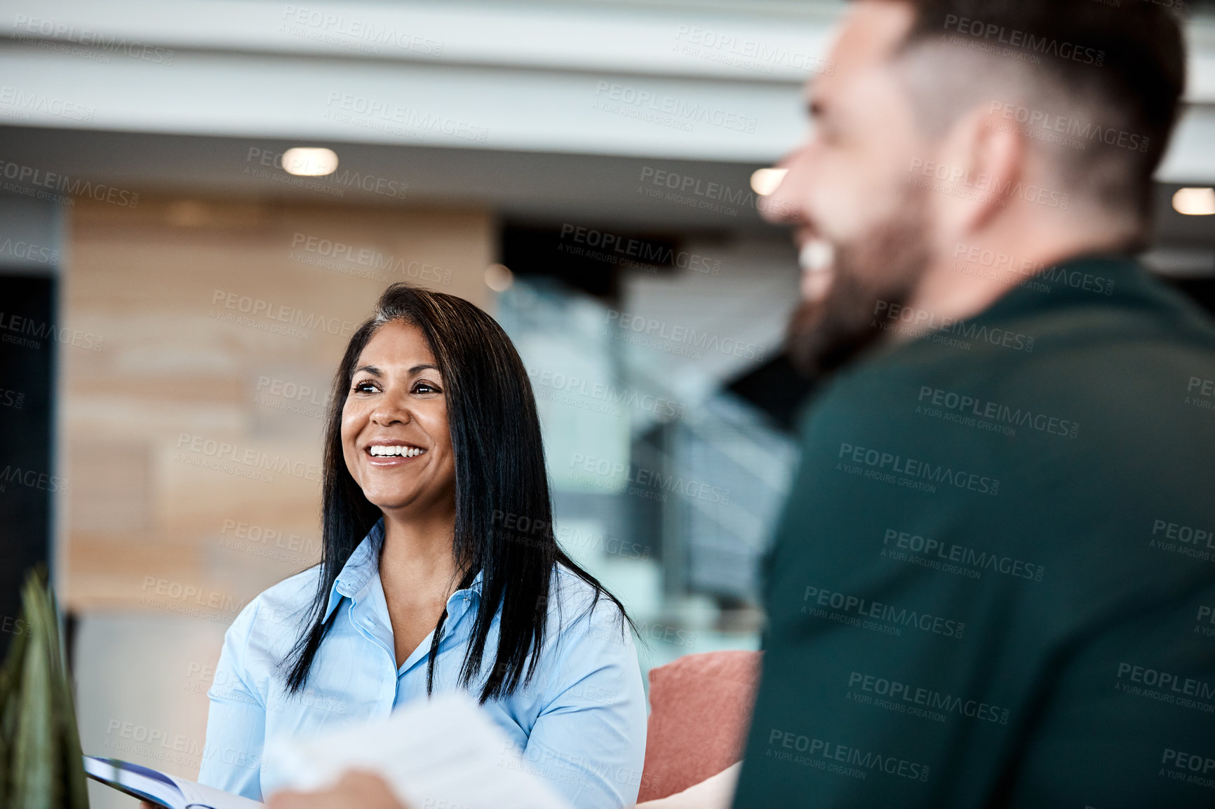 Buy stock photo Cropped shot of two business colleagues sitting down during a meeting in their office