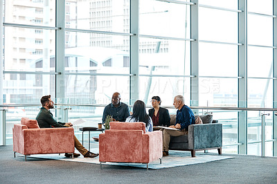 Buy stock photo Full length shot of a group of business colleagues talking while sitting in their office