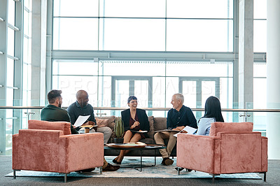 Buy stock photo Full length shot of a group of business colleagues talking while sitting in their office