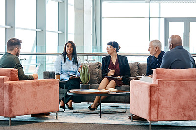 Buy stock photo Full length shot of a group of business colleagues talking while sitting in their office