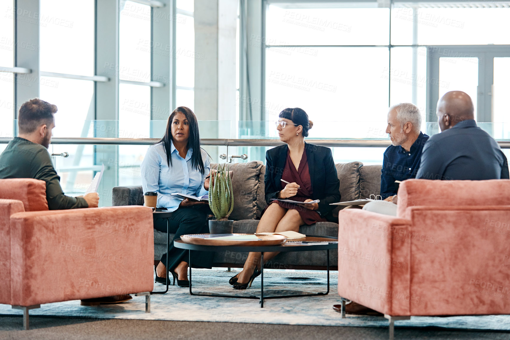 Buy stock photo Full length shot of a group of business colleagues talking while sitting in their office