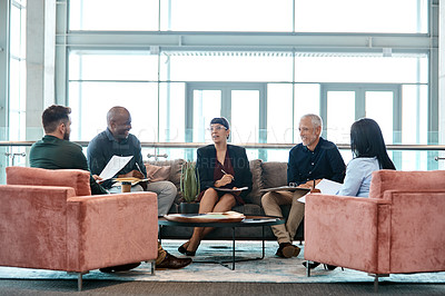 Buy stock photo Full length shot of a group of business colleagues talking while sitting in their office