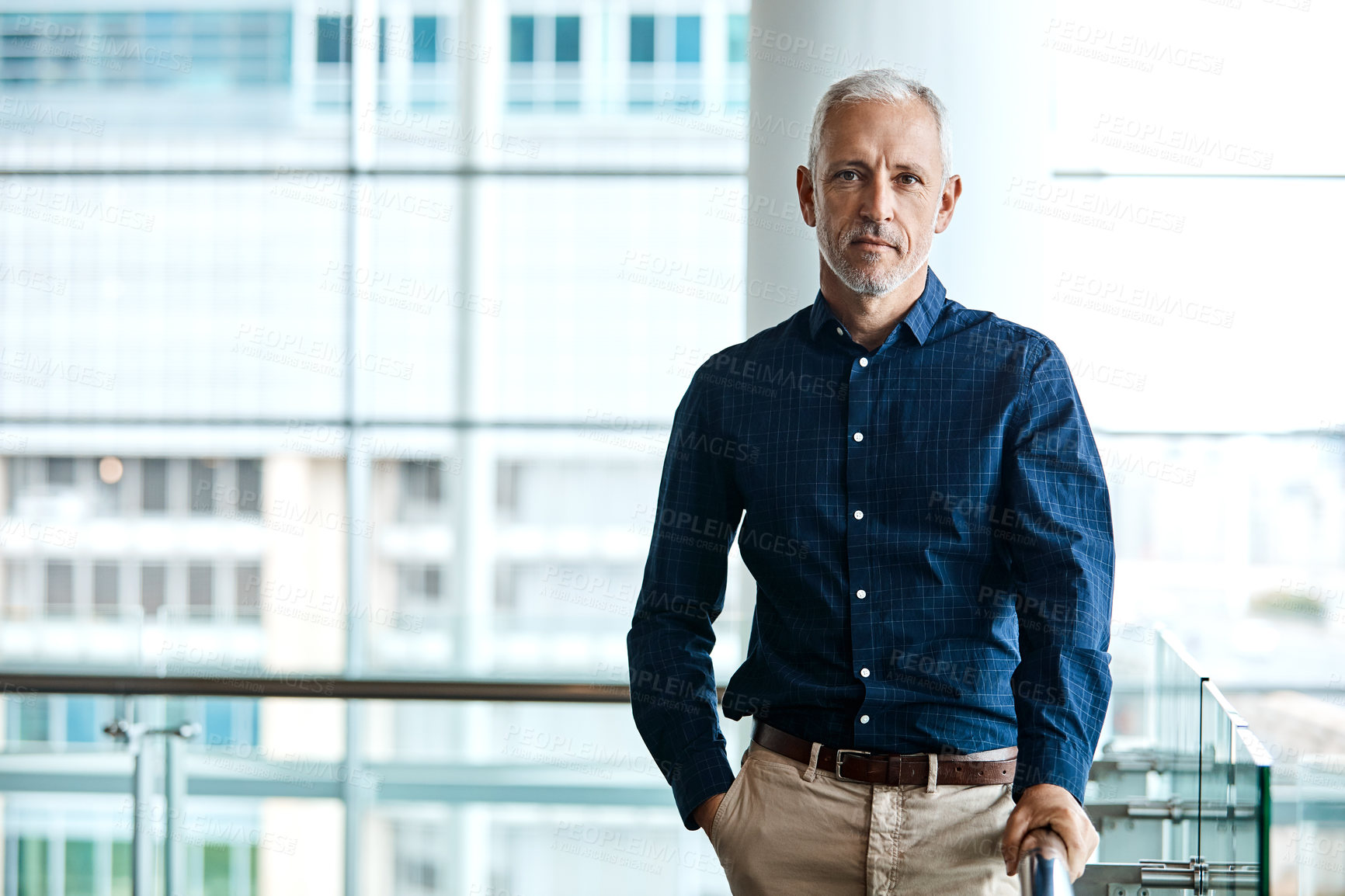 Buy stock photo Cropped portrait of a handsome businessman standing with his hand in his pocket in the office
