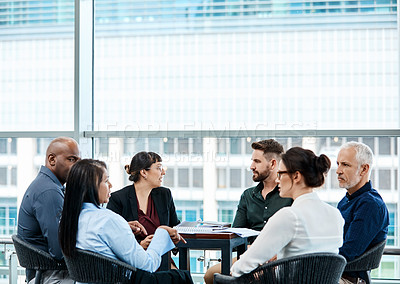 Buy stock photo Shot of a group of businesspeople during a boardroom meeting at work