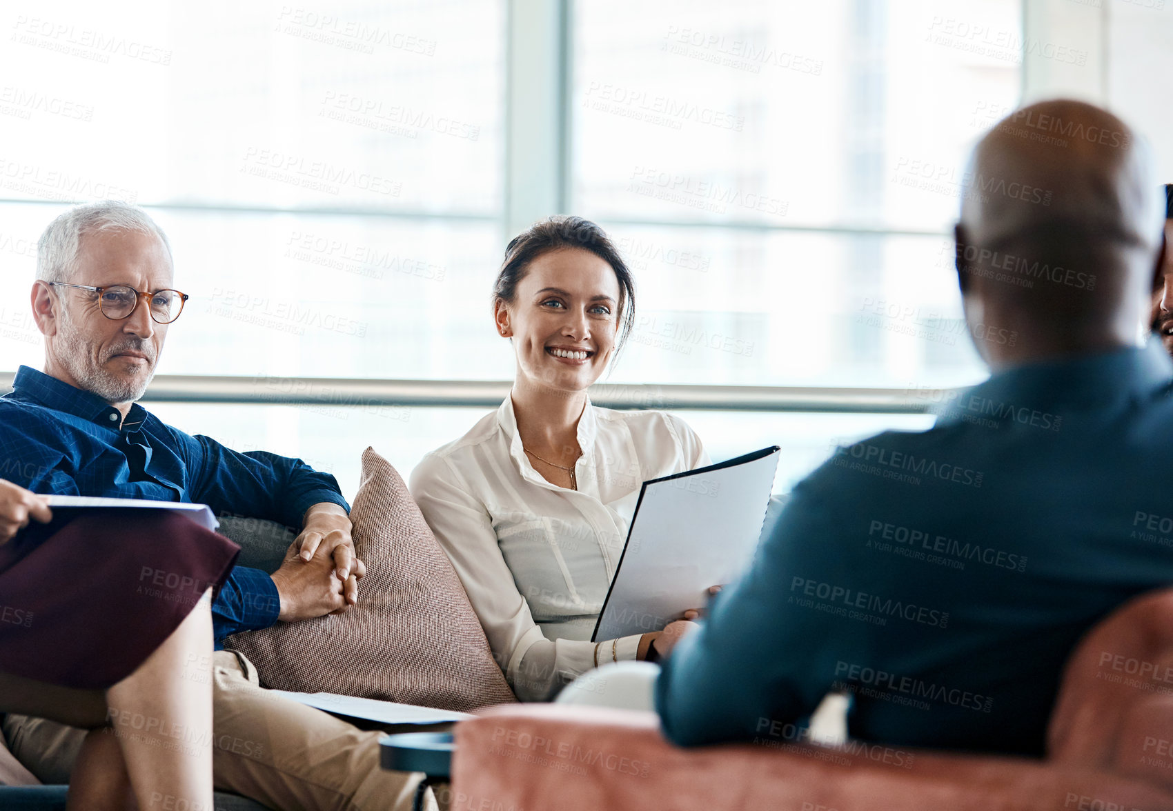 Buy stock photo Shot of a group of businesspeople having a meeting together at work