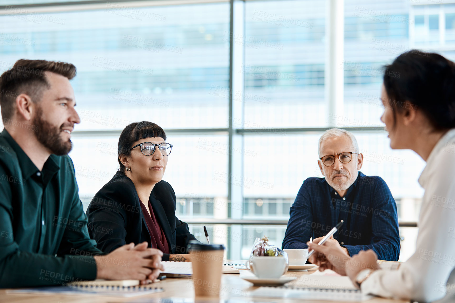 Buy stock photo Shot of a group of businesspeople during a boardroom meeting at work