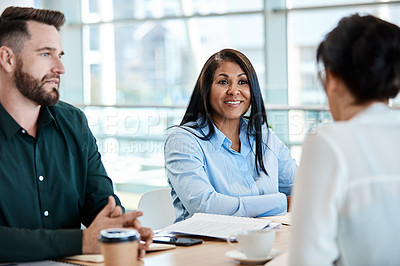 Buy stock photo Shot of a group of businesspeople during a boardroom meeting at work