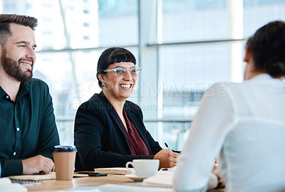 Buy stock photo Shot of a group of businesspeople during a boardroom meeting at work