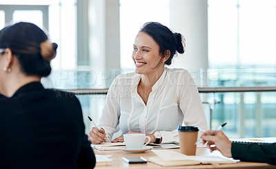 Buy stock photo Shot of an attractive businesswoman smiling during a meeting with colleagues at work