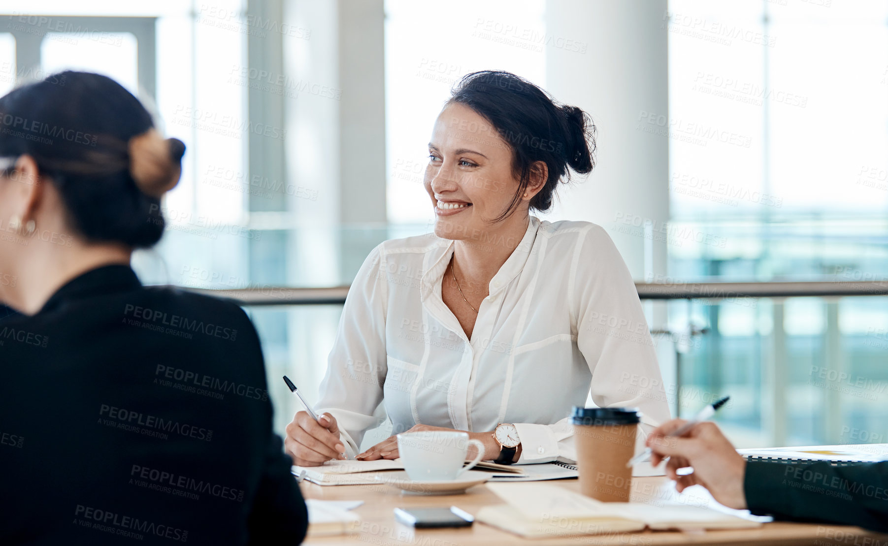 Buy stock photo Shot of an attractive businesswoman smiling during a meeting with colleagues at work