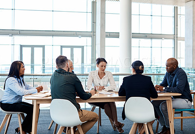 Buy stock photo Full length shot of a group of businesspeople during a boardroom meeting at work