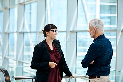 Buy stock photo Shot of a young businesswoman having a discussion with a senior staff member at work