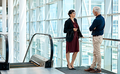 Buy stock photo Full length shot of two businesspeople having a discussion at work