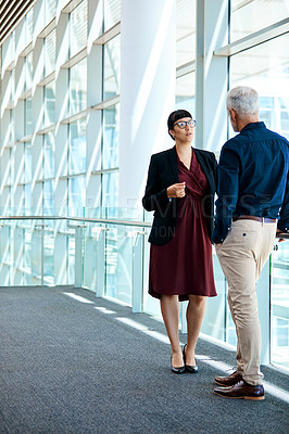 Buy stock photo Full length shot of two businesspeople having a discussion at work