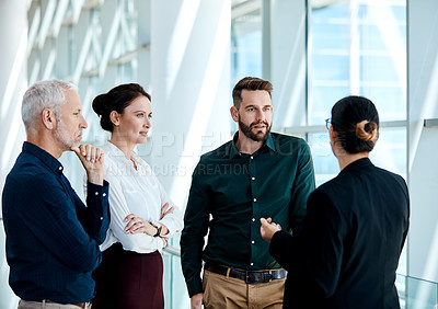 Buy stock photo Shot of a group of businesspeople having a discussion together at work