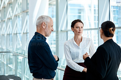 Buy stock photo Shot of a group of businesspeople having a discussion together at work