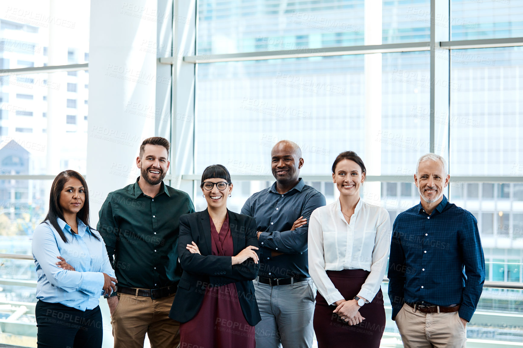 Buy stock photo Portrait of a group of cheerful businesspeople posing together at work