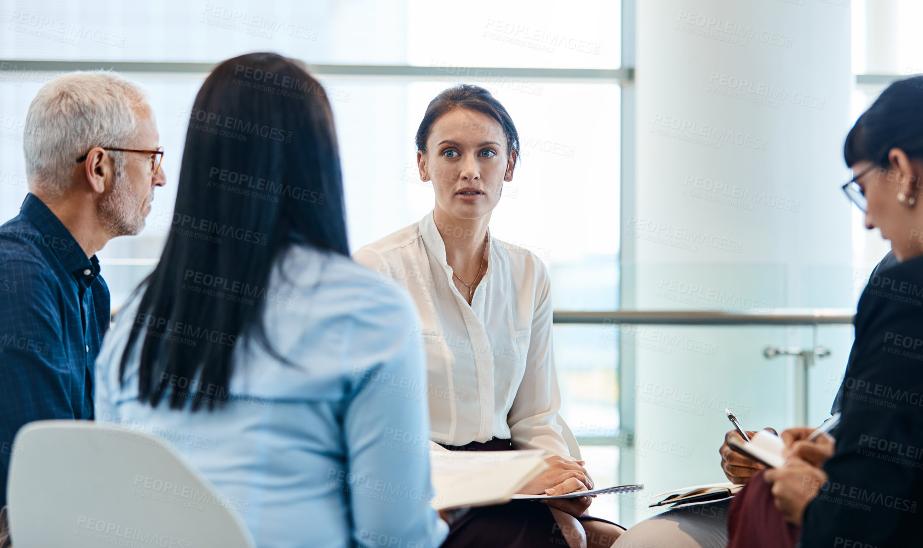 Buy stock photo Shot of a group of businesspeople during a meeting at work