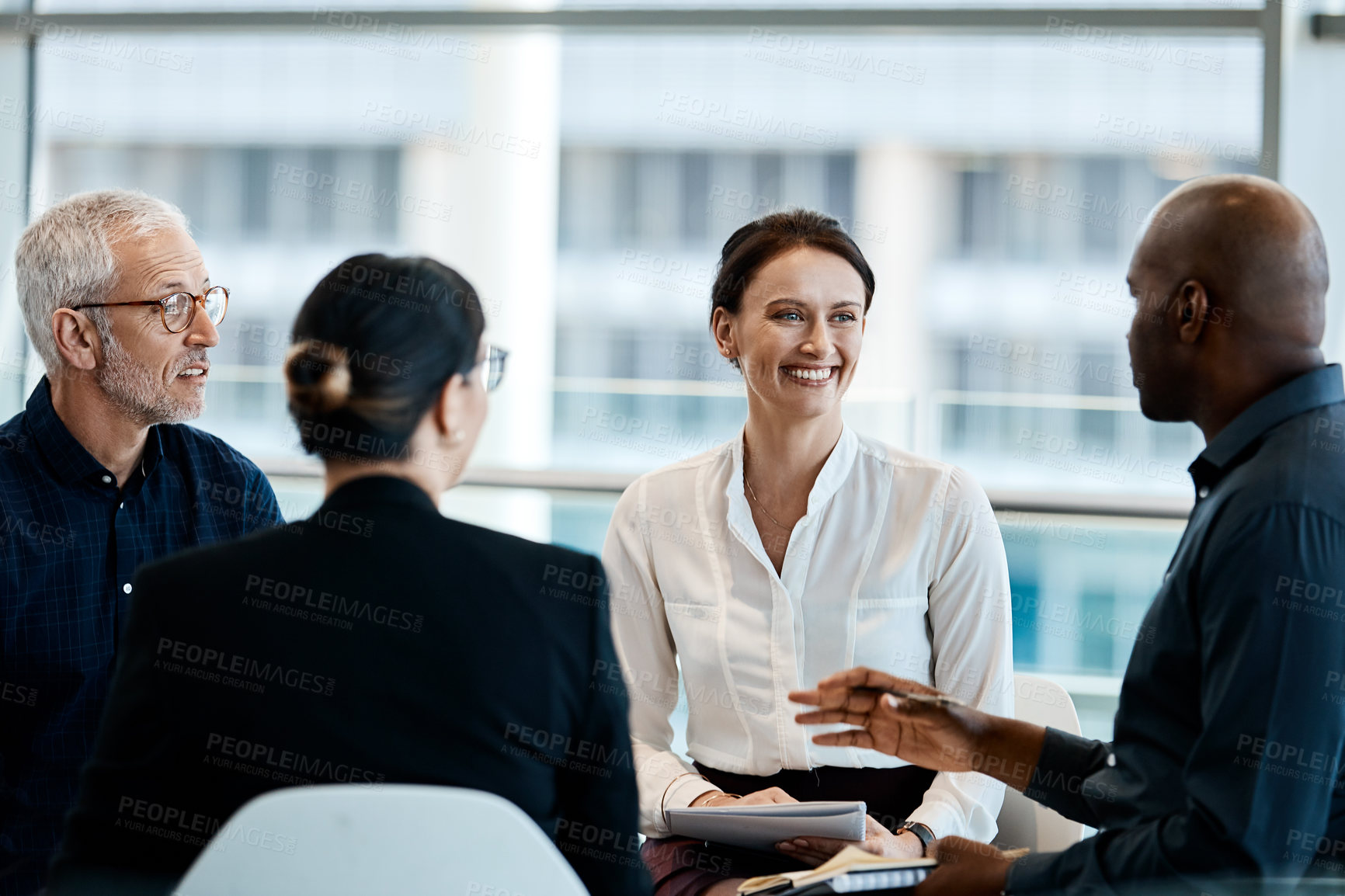 Buy stock photo Shot of a group of businesspeople during a meeting at work