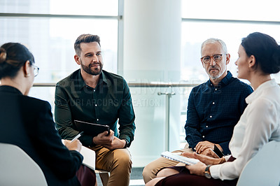 Buy stock photo Shot of a group of businesspeople having a meeting together at work