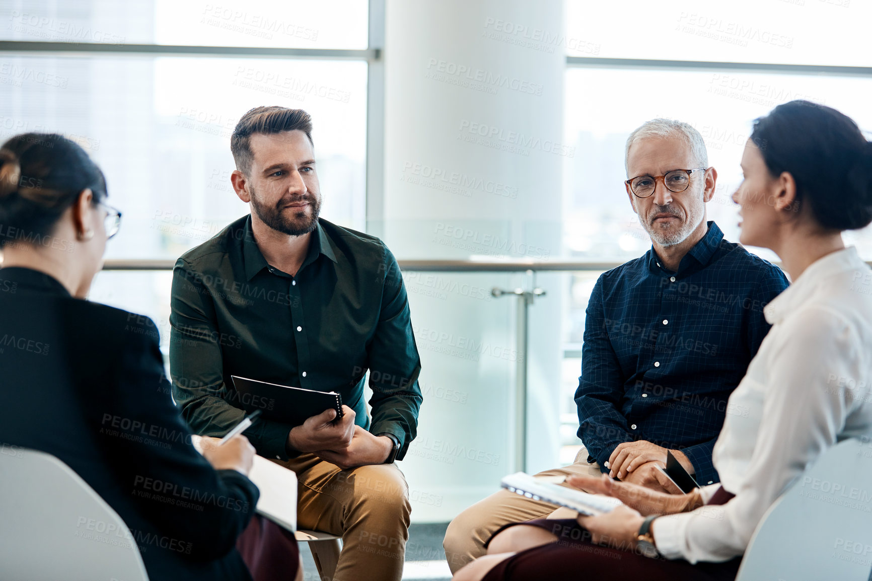 Buy stock photo Shot of a group of businesspeople having a meeting together at work