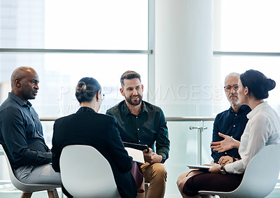 Buy stock photo Shot of a group of businesspeople having a meeting together at work