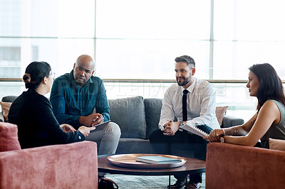 Buy stock photo Shot of a group of businesspeople having a meeting together at work