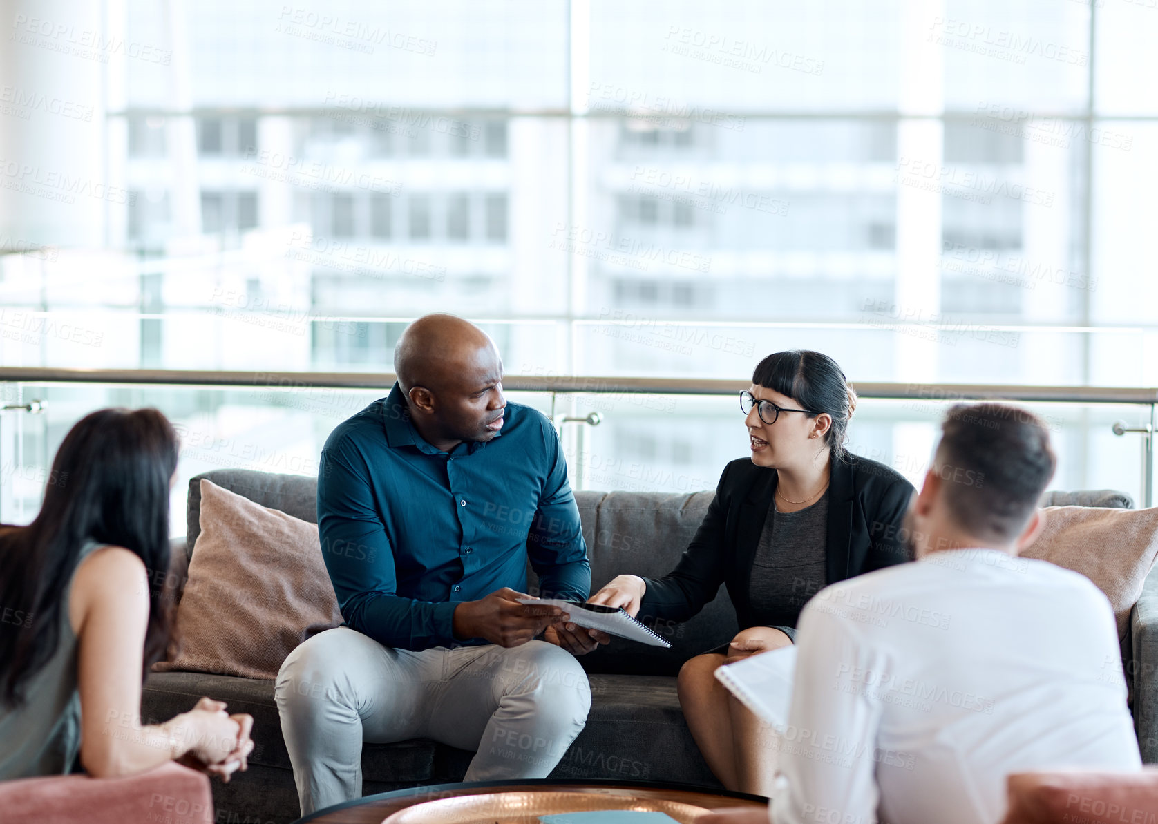 Buy stock photo Shot of a group of businesspeople having a meeting together at work