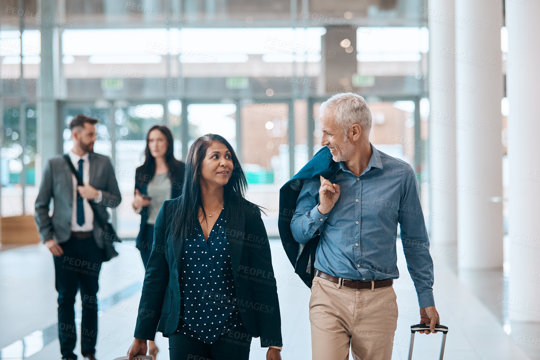 Buy stock photo Business people, smile and walking with suitcase for travel, work trip and partnership in airport. Employee, terminal lobby and luggage for international opportunity, journey or project collaboration