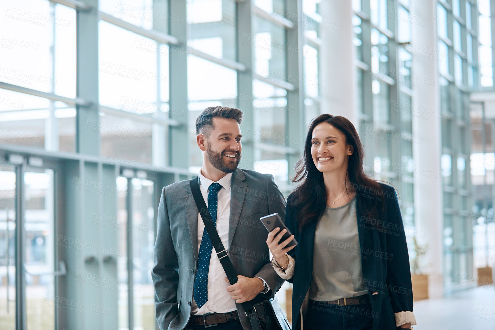 Buy stock photo Business people, smile and walking with phone for travel, work trip and partnership in airport lobby. Employees, friends and tech for international opportunity, journey and project collaboration