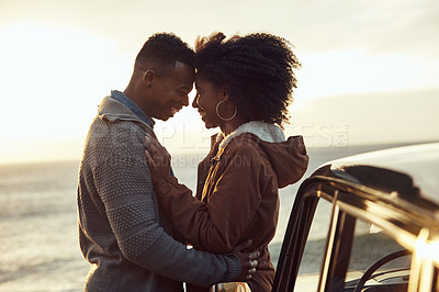Buy stock photo Cropped shot of an affectionate young couple holding each other while standing on the beach during a road trip