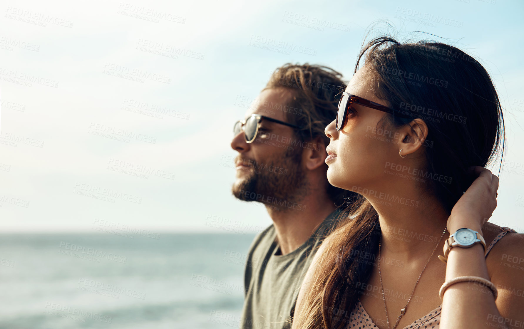 Buy stock photo Couple, relax and beach with sunglasses for sightseeing holiday, weekend or vacation together. Man, woman or chilling with partner on ocean coast for summer break, travel or bonding trip on space