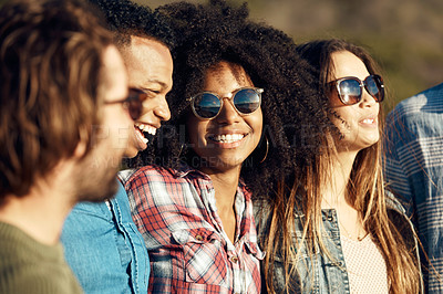 Buy stock photo Cropped shot of a diverse young group of friends socialising together on the beach during a road trip