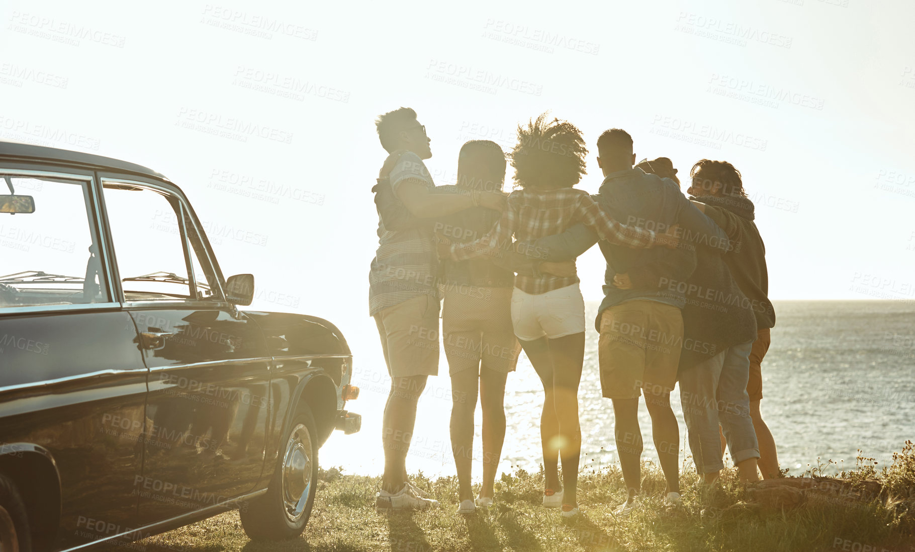 Buy stock photo View, friends and road trip by sea on vacation adventure, back and hug for bonding with sunshine. Group, car and people travel by ocean together for connection, embrace and holiday scenery outdoor
