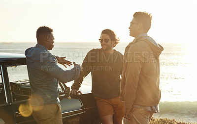 Buy stock photo Cropped shot of a diverse young group of friends socialising together at the beach during a road trip