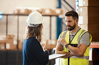 Buy stock photo Cropped shot of a handsome young male warehouse worker talking to his supervisor